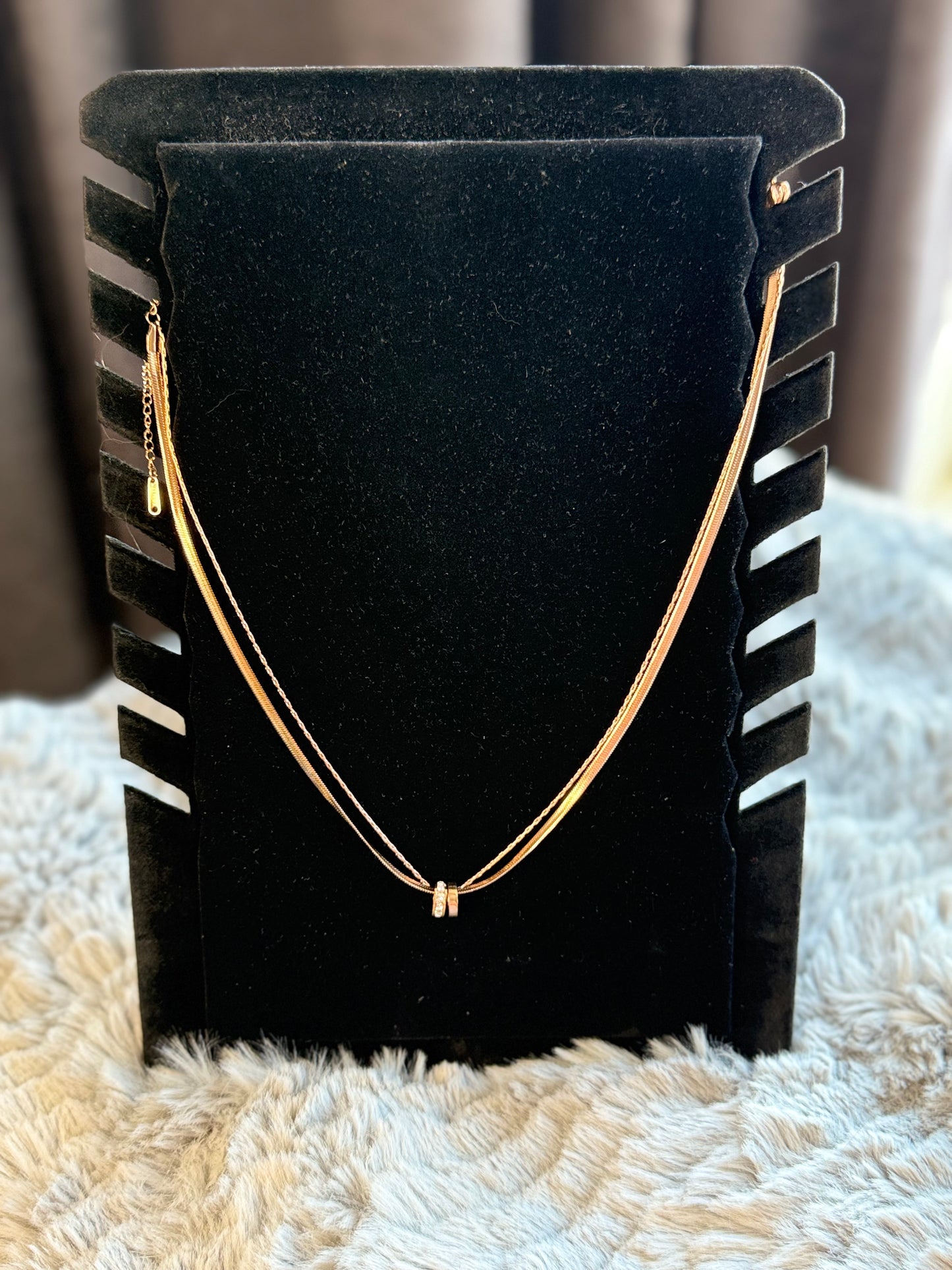 • Small dual-ring pendant with delicate crystal accents
